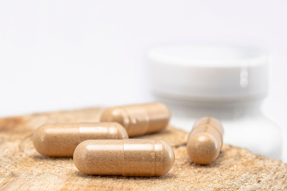 Doxwell Piles Relief Capsules – Ayurvedic herbal capsules on wooden surface