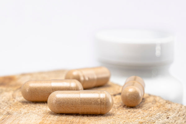 Doxwell Piles Relief Capsules – Ayurvedic herbal capsules on wooden surface