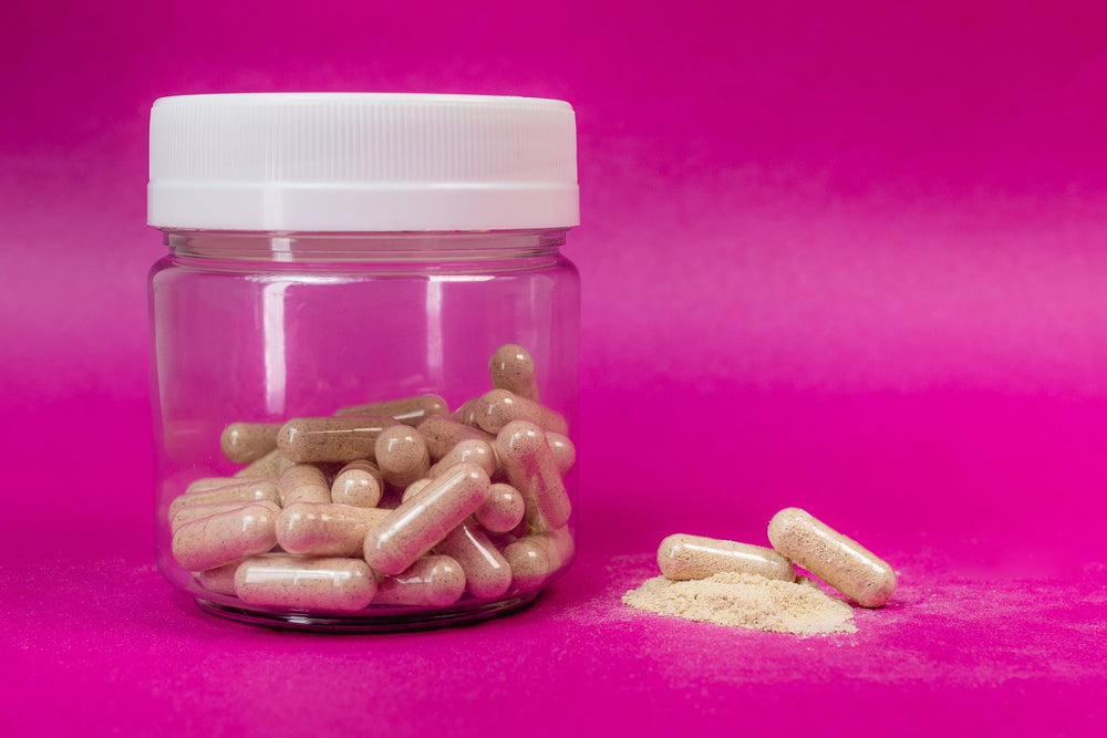 Doxwell Kamraj Churna – herbal powder jar on pink backdrop
