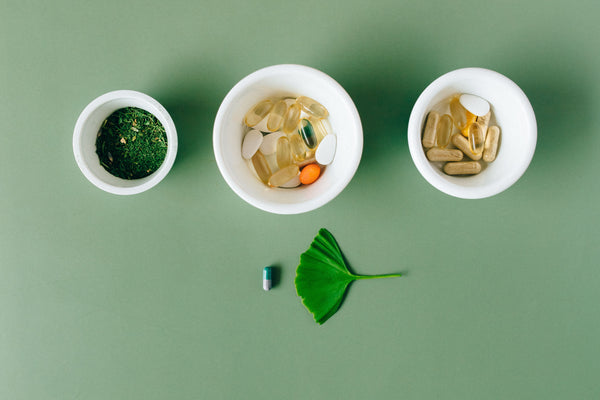 Doxwell Digestive Care Churna – herbal powder in ceramic bowls on green surface